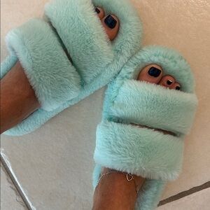 Green fuzzy used slippers for feet toes warm worn shoes well loved foot slides